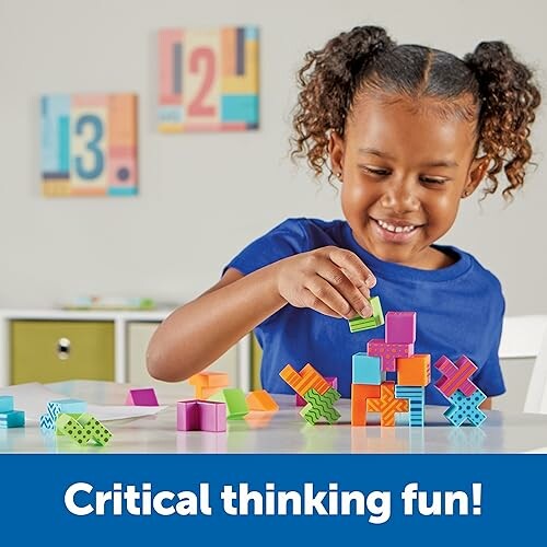 Child stacking colorful blocks with a smile